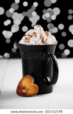 Close up photograph of a cup of hot chocolate with whipped cream