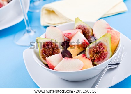 Close up photograph of a bowl of fresh summer fruits