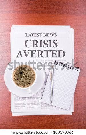 The newspaper LATEST NEWS with the headline CRISIS AVERTED  and coffee