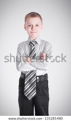 Boy with long tie crossed his arms