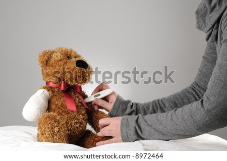 an injured teddy bear having a examination by a pediatrician