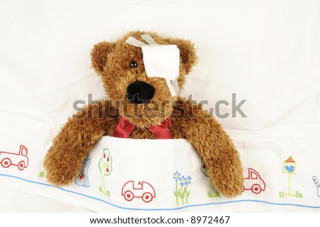 a teddy bear with an eye bandage at the hospital
