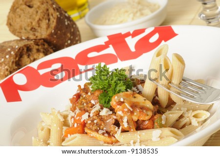 a plate with whole-wheat pasta and bolognese sauce