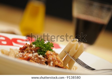 a plate with whole-wheat pasta and bolognese sauce