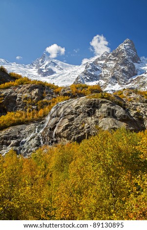 Russia. The mountains of the Caucasus. The snowy peaks. Autumn landscape waterfall, a glacier