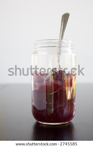 Cranberry sauce in a jar with a silver spoon