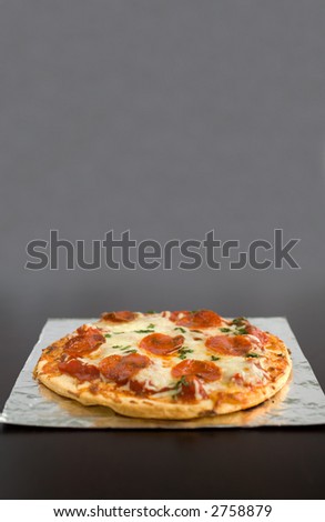 Pepperoni Pizza with mozzarella cheese and parsley fresh out of the oven place for text