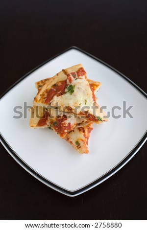 Slices of plain pizza stacked on a plate