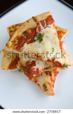 Slices of plain pizza stacked on a plate