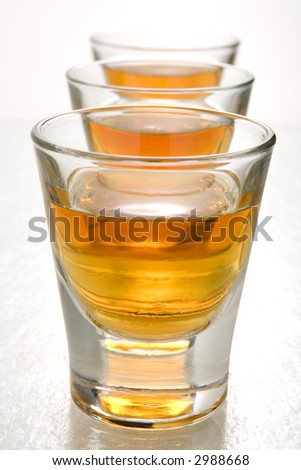 Three shots of scotch whiskey lined up in a row