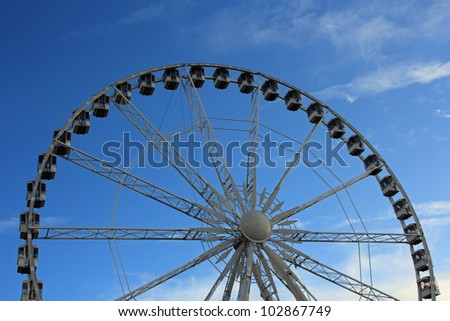 A Ferris wheel (also known as an observation wheel or big wheel) is a nonbuilding structure consisting of a rotating upright wheel with passenger cars