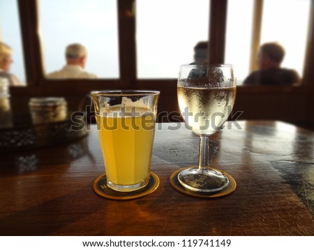 A glass of white wine and beer