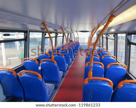 Interior of a bus with blue chairs