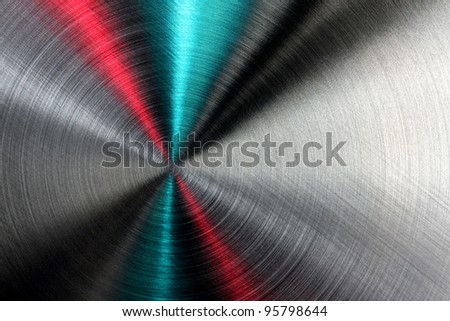 Shiny abstract metallic texture with blue, red and silver ray patterns.