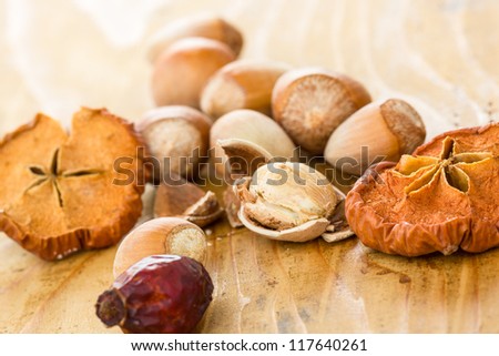 Dried Apples with Hazelnuts and Rose hip on a wooden Kitchen Table