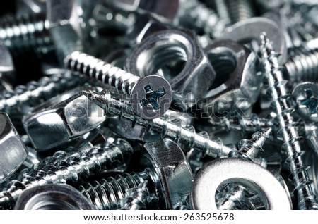 Couple on screws, bolts and nuts. Macro shot. Background.