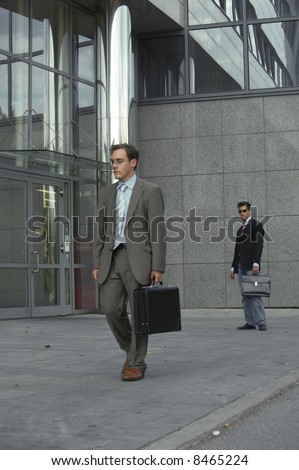 frustrated business man is walking away from his partner