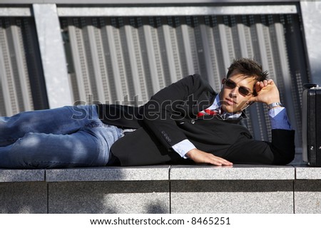 a young business man is enjoing his breaktime, while listening to music