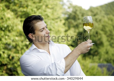 man holding up a glass of wine