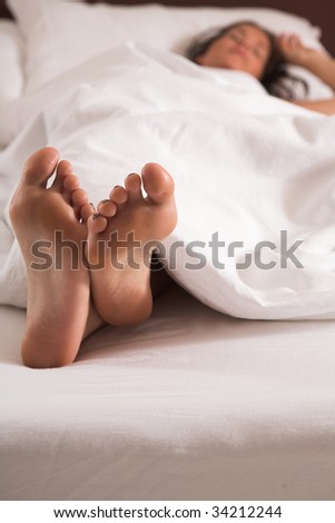 Bright Closeup of woman?s feet in bed