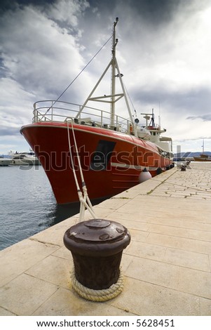 the dark red ship in the dock