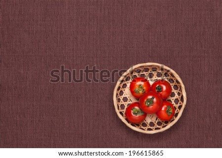 These are the tomatoes on the table and put it in a basket.