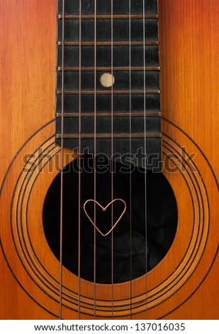 A heart lies on strings the guitar can be used as background