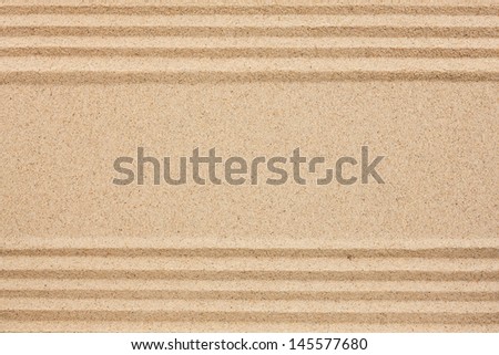 Straight lines in the sand with space for text