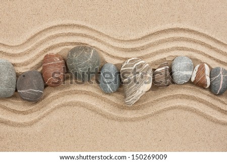 Striped stones on the sand,can be used as background