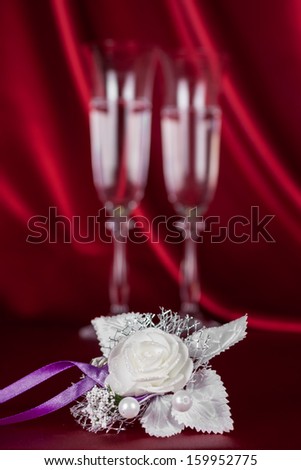 wedding flower on the background of two wine glasses, as the background