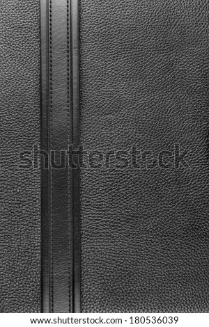 Black belt lies on the natural leather, can be used as a background, texture, menu
