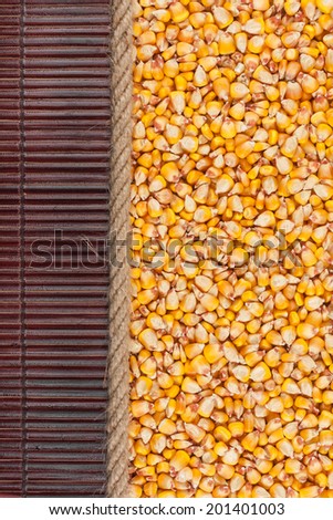 Corn  lying on dark bamboo mat, for menu, can be used as background