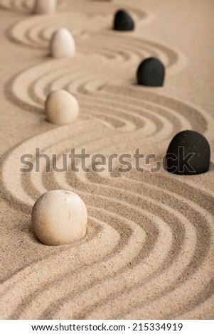 line black and white  stones, standing on the sand, can be used as background
