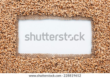 Frame made of burlap with wheat, on a white background