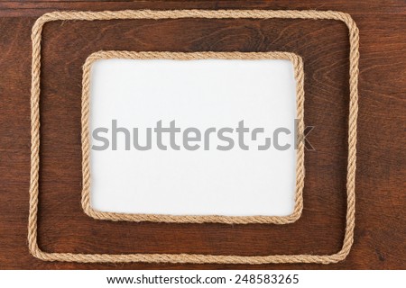 Two frames of rope lying on a wooden surface with a white background, for your text
