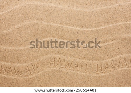 Hawaii  inscription on the wavy sand, as background