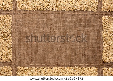 Beautiful frame with oats on sackcloth, with place for your text, drawing