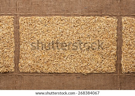 Oats grains on sackcloth, with place for your text, drawing