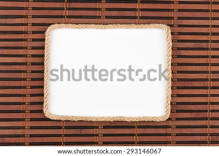 Frame of rope lying on a bamboo mat with a white background, for your text