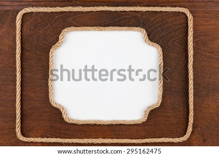 Two frame of rope with a white background, lies on  wooden surface, with place for your text