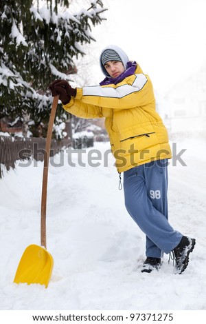 Young man with snow shovel