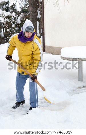 Young man with snow shovel