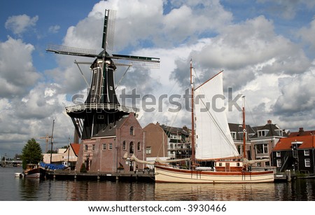Scenic Dutch Windmill By The River In Haarlem, The Netherlands