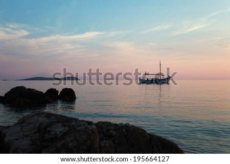 Old wooden little boat wait for the sunset in Greece / Boat on the sunset