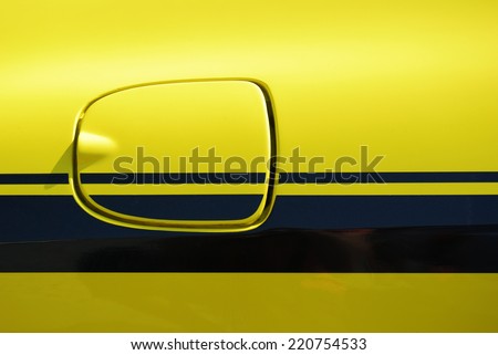 Yellow vehicle fuel filler cap closeup detail