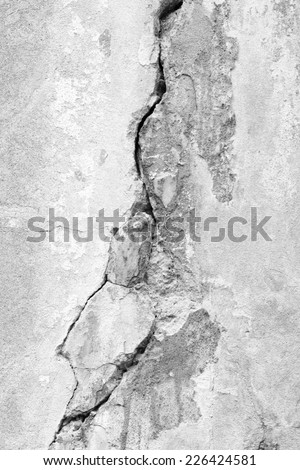 Old damaged wall with a big crack in black and white tone