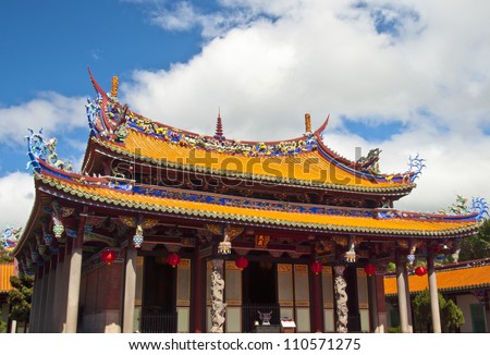 Taiwan Asian outdoor temple cultural totem carving wood yellow red white blue sky background Confucian temple
