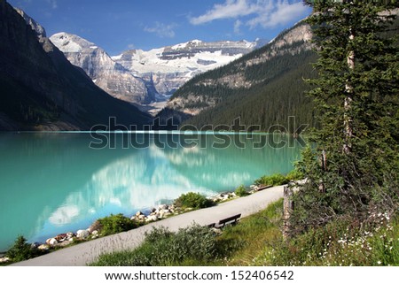 Mount Lefroy (left) Mount Victoria (center), Lake Louise, Banff National Park, Alberta, Canada.  Pathway leads around Lake Louise and to the Plains of Six Glaciers Tea House.