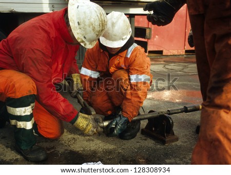 SEXBIERUM THE NETHERLANDS-CIRCA NOVEMBER 2008 Rig-personnel in the salt-mining industry being occupied with wireline-tools in Sexbierum the Netherlands on circa November 2008 SEXBIERUM THE NETHERLANDS-CIRCA NOVEMBER 2008 Rig-personnel in the salt-mining industry being occupied with wireline-tools in Sexbierum the Netherlands on circa November 2008