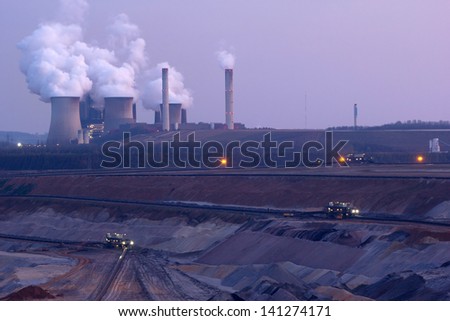 Open cast mine lignite and cooling towers of a large power station Open cast mine lignite and cooling towers of a large power station